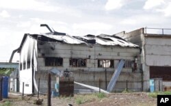 This frame from a video shows a destroyed barracks at a prison in Olenivka, in an area controlled by Russian-backed separatist forces, eastern Ukraine, July 29, 2022. Russia and Ukraine accused each other Friday of shelling the prison.
