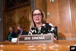 Sen. Kyrsten Sinema arrives for a meeting of the Senate Homeland Security Committee at the Capitol in Washington, Aug. 3, 2022.