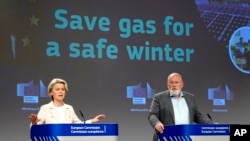 European Commission President Ursula von der Leyen, left, and Commission Vice President Frans Timmermans address a media conference at EU headquarters in Brussels, July 20, 2022. 