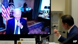 President Joe Biden listens as SK Group Chairman Chey Tae-won, right, speaks from the Roosevelt Room of the White House, July 26, 2022. The president is expected to speak with China's Xi Jinping later this week. 