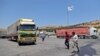 FILE - A convoy transporting humanitarian aid crosses into Syria from Turkey through the Bab al-Hawa border crossing on July 8, 2022. 
