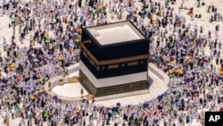 FILE - Muslim pilgrims walk around the Kaaba, the cubic building at the Grand Mosque, during the annual hajj pilgrimage, in Mecca, Saudi Arabia, on July 10, 2022.