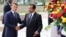 Cameroon's President Paul Biya shakes hands with his French counterpart Emmanuel Macron at the presidencial palace in Yaounde, Cameroon, July 26, 2022. 