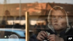 FILE: A young boy from Ukraine eats chocolate in a hostel in Budapest, Hungary, March 24, 2022.