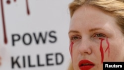 Yuliana, girlfriend of a defender of the Azovstal Iron and Steel Works in Mariupol, attends a rally demanding to recognise Russia as a state sponsor of terrorism after killing Ukrainian prisoners of war (POWs) in a prison in Olenivka, outside of Donetsk, 