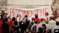 Indigenous Canadians display a banner calling on Pope to rescind the Doctrine of Discovery in Quebec City, Canada, Thursday, July 28, 2022.