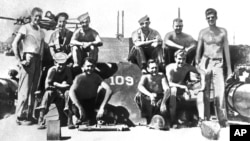 FILE - Lieutenant John F. Kennedy, right, and his PT 109 crew are shown somewhere in the South Pacific, July 1943.