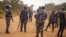 FILE - Police officers secure an area in Kayunga, Uganda, Dec. 14, 2021. Uganda on Monday deployed a police force to its border with the Democratic Republic of Congo after a deadly shooting there involving U.N. peacekeeping troops.