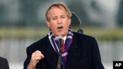 FILE - Texas Attorney General Ken Paxton speaks at a rally in Washington, Jan. 6, 2021.