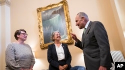 Senate Majority Leader Chuck Schumer, D-N.Y., welcomes Paivi Nevala, minister counselor of the Finnish Embassy, left, and Karin Olofsdotter, Sweden's ambassador to the U.S., just before the Senate vote to ratify NATO membership for the two nations, in Washington, Aug. 3, 2022.