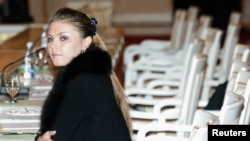 FILE - Former World and Olympic champion Russian gymnast Alina Kabayeva takes her seat before the first meeting of a new representative and consultative body, the Public Chamber, at the Grand Kremlin Palace's St. George's hall in Moscow, Jan. 22, 2006.