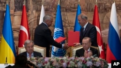 Turkish President Recep Tayyip Erdogan, right, and U.N. Secretary General Antonio Guterres lead a signing ceremony at Dolmabahce Palace in Istanbul, Turkey, Friday, July 22, 2022.