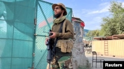 A Taliban fighter stands guard near the site where al-Qaida leader Ayman al-Zawahiri was killed in a U.S. strike over the weekend, in Kabul, Afghanistan, Aug. 2, 2022. 