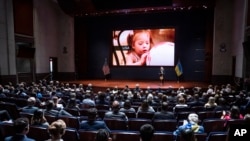 Olena Zelenska, the first lady of Ukraine, introduces members of Congress to a young victim of a Russian bombing during her address on Capitol Hill in Washington, July 20, 2022.