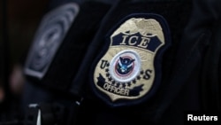 FILE - The badge of a field office director for the U.S. Immigration and Customs Enforcement's Enforcement and Removal Operations in Hawthorne, California, on March 1, 2020.