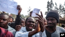 FILE - Demonstrators face off with police during a protest against the United Nations peacekeeping force (MONUSCO) deployed in the Democratic Republic of the Congo in Sake, some 24 kilometers west of Goma, July 27, 2022. 
