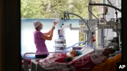 A medical worker takes care of people injured during Russian shelling Thursday in a hospital in Vinnytsia, Ukraine, July 15, 2022.