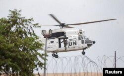 A United Nations Organization Stabilization Mission in the Democratic Republic of the Congo (MONUSCO) peacekeeper rides on a helicopter above the compound of U.N. peacekeeping force's warehouse in Goma in the North Kivu province of the Democratic Republic of Congo, July 26, 2022.