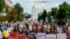 Protesters attend a rally in support of Ukrainian soldiers from the Azov Regiment who were captured by Russia in May after the fall of Mariupol, in Kyiv, Ukraine, Saturday, July 30, 2022.