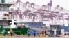FILE - Workers disinfect an area at a port in Qingdao, in China's eastern Shandong province on July 13, 2022. 