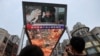 A giant screen shows news footage of Chinese President Xi Jinping visiting Xinjiang Uyghur Autonomous Region, at a shopping center, in Beijing, China, July 15, 2022. 
