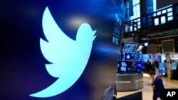 FILE: The logo for Twitter appears above a trading post on the floor of the New York Stock Exchange, Nov. 29, 2021.
