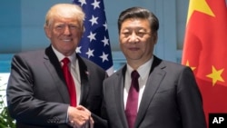 FILE - President Donald Trump and Chinese President Xi Jinping shake hands as they arrive for a meeting on the sidelines of the G-20 Summit in Hamburg, Germany, July 8, 2017. Ambassador Cui said that both leaders have “set a constructive tone” in their bilateral relationship.