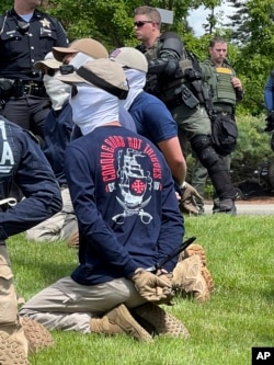 The group was found packed into the back of a U-Haul truck with riot gear.