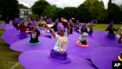 Members of the Mahogany carnival group take part in a rehearsal for their upcoming performance at the Platinum Jubilee Pageant, at Queens Park Community School, in north London, May 28, 2022.