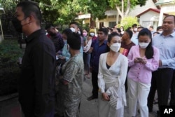 People line up before voting at a polling station in Takhmua, in Kandal province, southeast of Phnom Penh, Cambodia, June 5, 2022.