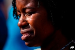 File - A person is overcome with emotions outside the scene of a shooting at a supermarket, in Buffalo, N.Y., May 15, 2022, one of several shootings in the U.S.. in recent weeks.
