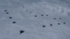 FILE - In this photo provided by South Korea Defense Ministry, US and South Korean fighter jets fly in formation during a joint drill, June, 7, 2022. 