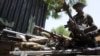 FILE - A sector commander of the Multinational Joint Task Force displays arms and ammunition recovered from Islamist insurgents during a clash with soldiers in the remote northeast town of Baga, Borno State, Nigeria, April 30, 2013. 