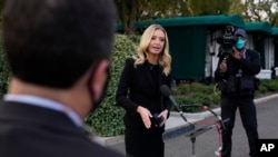 White House press secretary Kayleigh McEnany, talks to the media, Oct. 4, 2020, outside the White House in Washington. 