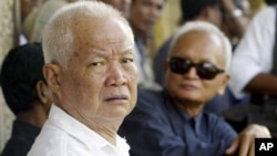 Former Khmer Rouge leaders Khieu Samphan, left, and Nuon Chea, right, look on during the funeral for Khieu Ponnary, the first wife of Khmer Rouge leader Pol Pot, in 2003. 
