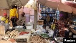FILE - Vendors are seen with their goods at Mvog Ada market in Yaounde, Cameroon, Jan. 29, 2022. 