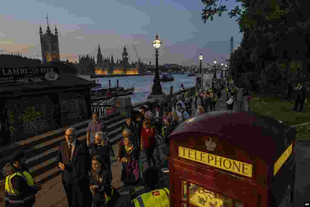 People queue to pay their respects to late Queen Elizabeth II who is lying in state at Westminster Hall in London, Sept. 14, 2022. The queen will lie in state in Westminster Hall for four days before her funeral on Monday.