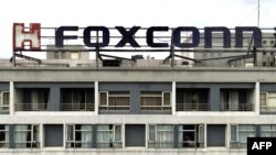 FILE - This aerial photo shows a Foxconn logo on a building in Tucheng district, New Taipei City, on May 6, 2022.