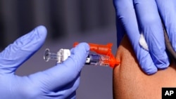 FILE - A patient is given a flu vaccine at a community clinic in Lynwood, Calif., Oct. 28, 2022. The Centers for Disease Control and Prevention estimates that in the week set to end Dec. 24, 2022, the omicron subvariant XBB will account for 18.3% of U.S. COVID-19 cases.