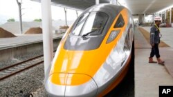 FILE - A worker walks near a new Comprehensive Inspection Train unit at the Jakarta-Bandung Fast Railway station in Tegalluar, West Java, Indonesia, Oct. 13, 2022.