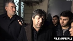 FILE - Avaz Zeynalli, center, owner and chief editor of the independent news outlet Xural TV, is seen in this undated photo.