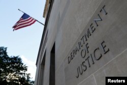 FILE - Signage is seen at the United States Department of Justice headquarters in Washington, Aug. 29, 2020. 