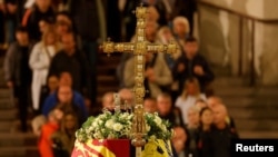 Members of the public pay their respects as they pass the coffin of Queen Elizabeth II, lying in state in Westminster Hall, at the Palace of Westminster, London, Sept. 15, 2022.