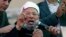 FILE - Egyptian cleric Sheik Youssef al-Qardawi speaks to the crowd as he leads Friday prayers in Tahrir Square in Cairo, Egypt, Feb. 18, 2011. Al-Qardawi, a cleric who was seen as the spiritual leader of the pan-Arab Muslim Brotherhood, has died at the age of 96.