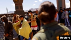 FILE - Migrants, mostly from Venezuela, walk after being detained by U.S. Border Patrol agents after crossing into the United States from Mexico to turn themselves in to request asylum, in El Paso, Texas, Sept. 14, 2022.