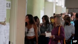 People wait to vote at a polling station in Rome, Italy, Sept. 25, 2022. 