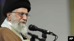 In this picture released by official website of the office of the Iranian supreme leader, Supreme Leader Ayatollah Ali Khamenei attends a meeting with a group of Qom residents, in a mosque at his residence in Tehran, Jan. 9, 2018. 