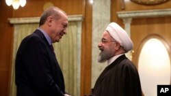 FILE - Turkey's President Recep Tayyip Erdogan, left, and Iran's President Hassan Rouhani greet each other before a meeting with Russia's President Vladimir Putin, in Sochi, Russia, Nov. 22. 2017.