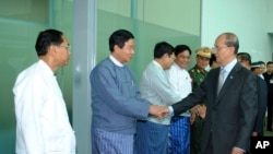 Burma's President Thein Sein, right, is seen off by officials at Rangoon International Airport before heading to Europe for a trip that will include visits to England and France, July 14, 2013, in Rangoon, Burma.