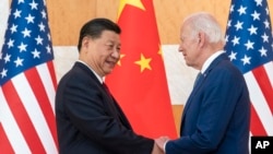 FILE - U.S. President Joe Biden, right, and Chinese President Xi Jinping shake hands before a meeting on the sidelines of the G-20 summit meeting on Nov. 14, 2022, in Bali, Indonesia. 